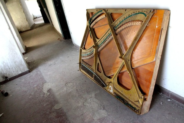 the-soundboard-of-a-piano-lies-abandoned-in-one-of-the-backstage-corridors-near-the-top-of-the-building