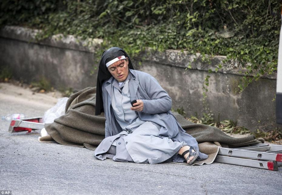 3789844400000578-3755722-Bloodied_An_injured_nun_checks_her_mobile_phone_as_she_lies_near-a-1_1472026812409