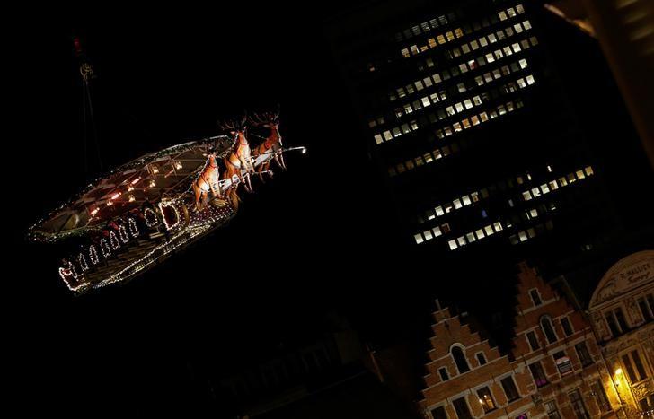 Guests enjoy dinner at the table "Santa in the sky", lifted by a crane and decorated to match the appearance of a "Santa Sleigh" as part as the Christmas festivities, in Brussels, Belgium, November 25, 2016. Picture taken November 25, 2016.   REUTERS/Yves Herman