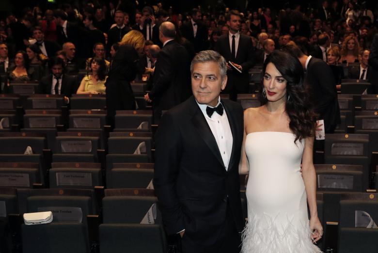 Actor George Clooney and his wife Amal pose before the start of the 42nd Cesar Awards ceremony in Paris. REUTERS/Philippe Wojazer