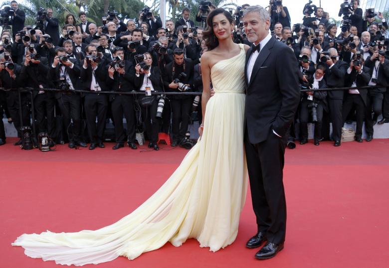 George Clooney and Amal pose on the red carpet for the screening of the film "Money Monster" out of competition at the 69th Cannes Film Festival in Cannes. REUTERS/Regis Duvignau