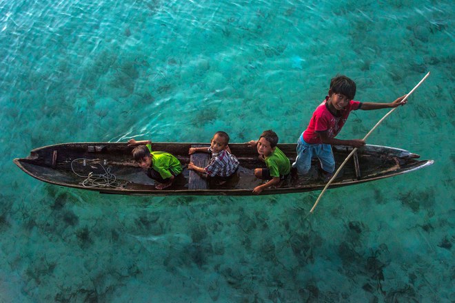 Pic by Claudio Sieber/Caters News - (Pictured: Sea Bajau who live within a basic setup on their handmade houseboats (called lepa lepa) 30/05/2017.) - THESE fascinating images reveal what life is like for the Bajau people - a nomadic tribe who spend their lives on the water. The group have been dubbed sea gypsies thanks to the fact they continue to live a seaborne lifestyle.The striking images - taken by photographer Claudio Sieber - show youngsters out catching fish in long narrow canoes. He took the pictures off the coast of Borneo where the Bajau are able to dive up to 20 metres without the use of modern scuba gear.They even reportedly experience land sickness when they leave the water. SEE CATERS COPY.