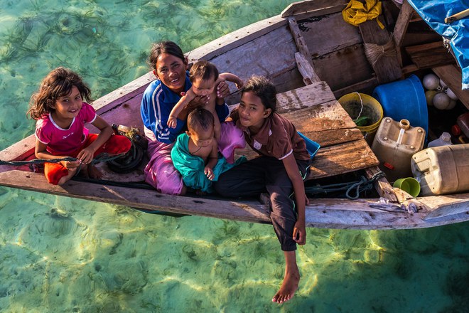 Pic by Claudio Sieber/Caters News - (Pictured: Sea Bajau who live within a basic setup on their handmade houseboats (called lepa lepa) 30/05/2017.) - THESE fascinating images reveal what life is like for the Bajau people - a nomadic tribe who spend their lives on the water. The group have been dubbed sea gypsies thanks to the fact they continue to live a seaborne lifestyle.The striking images - taken by photographer Claudio Sieber - show youngsters out catching fish in long narrow canoes. He took the pictures off the coast of Borneo where the Bajau are able to dive up to 20 metres without the use of modern scuba gear.They even reportedly experience land sickness when they leave the water. SEE CATERS COPY.