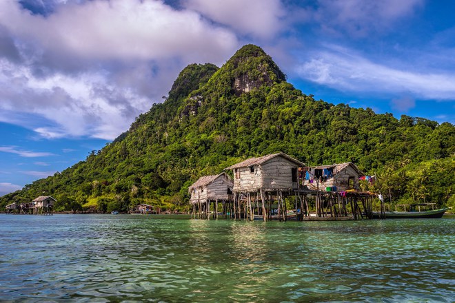 Pic by Claudio Sieber/Caters News - (Pictured: The village of the Bajau. 01/06/2017.) - THESE fascinating images reveal what life is like for the Bajau people - a nomadic tribe who spend their lives on the water. The group have been dubbed sea gypsies thanks to the fact they continue to live a seaborne lifestyle.The striking images - taken by photographer Claudio Sieber - show youngsters out catching fish in long narrow canoes. He took the pictures off the coast of Borneo where the Bajau are able to dive up to 20 metres without the use of modern scuba gear.They even reportedly experience land sickness when they leave the water. SEE CATERS COPY.