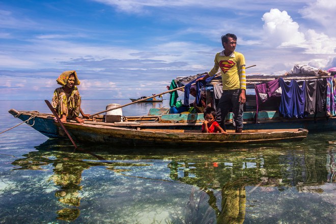 Pic by Claudio Sieber/Caters News - (Pictured: Sea Bajau who live within a basic setup on their handmade houseboats (called lepa lepa) 25/05/2017.) - THESE fascinating images reveal what life is like for the Bajau people - a nomadic tribe who spend their lives on the water. The group have been dubbed sea gypsies thanks to the fact they continue to live a seaborne lifestyle.The striking images - taken by photographer Claudio Sieber - show youngsters out catching fish in long narrow canoes. He took the pictures off the coast of Borneo where the Bajau are able to dive up to 20 metres without the use of modern scuba gear.They even reportedly experience land sickness when they leave the water. SEE CATERS COPY.