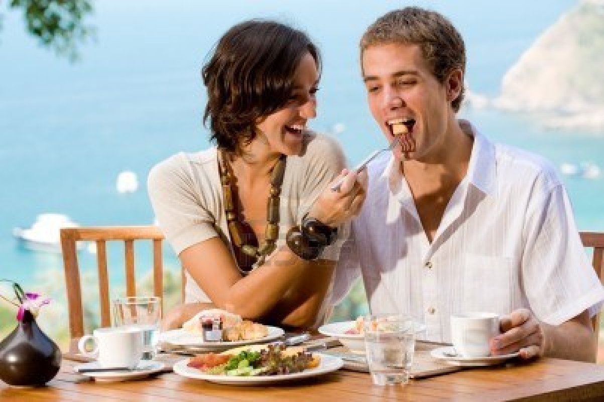 2634957-a-young-couple-enjoying-breakfast-outside-with-an-ocean-backdrop