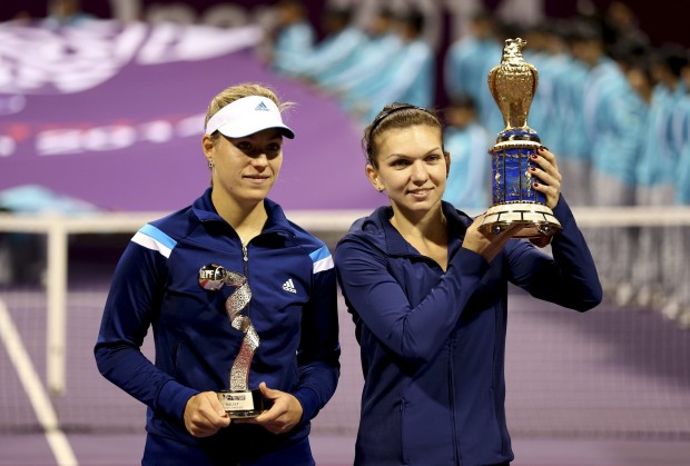 Simona Halep and Angelique Kerber pose with their trophies after their women’s singles final match at the Qatar Open tennis tournament in Doha