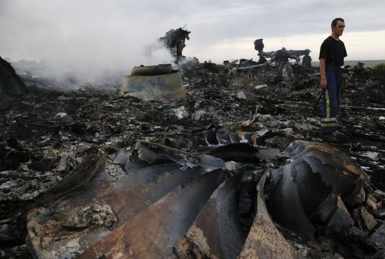 Emergencies Ministry member walks at the site of a Malaysia Airlines Boeing 777 plane crash near the settlement of Grabovo in the Donetsk region