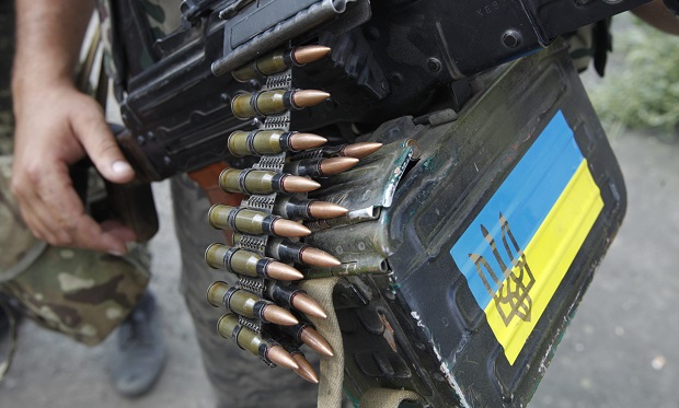 A Ukrainian serviceman guards a checkpoint near Donetsk