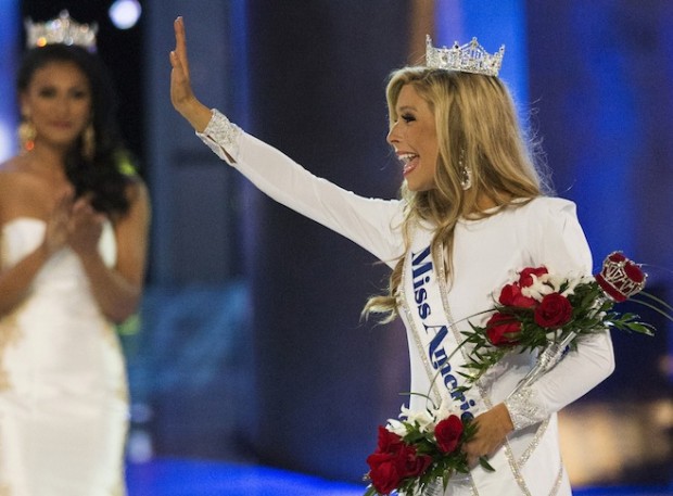 Miss New York Kira Kazantsev waves near Miss America 2014 Nina Davuluri after she was crowned as the winner of the 2015 Miss America Competition in Atlantic City, New Jersey