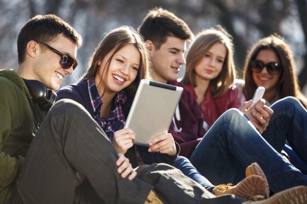 Young and happy urban people having fun with digital tablet