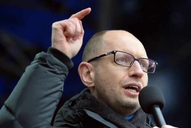 Arseniy Yatsenyuk, one of the leaders of the opposition Batkivshchyna party, gestures as he speaks during a Ukrainian opposition rally on Independence Square in Kiev on February 9, 2014. An estimated 70,000 pro-Western Ukrainians thronged the heart of Kiev on February 9 vowing never to give up their drive to oust President Viktor Yanukovych for his alliance with old master Russia. Wearing blue and yellow ribbons – the colours of both Ukraine and the European Union – the crowd sreceived a religious blessing before opposition leaders took to a podium on Independence Square in a bid to ratchet up pressure on Yanukovych to appoint a new pro-Western government. AFP PHOTO/ SERGEI SUPINSKY