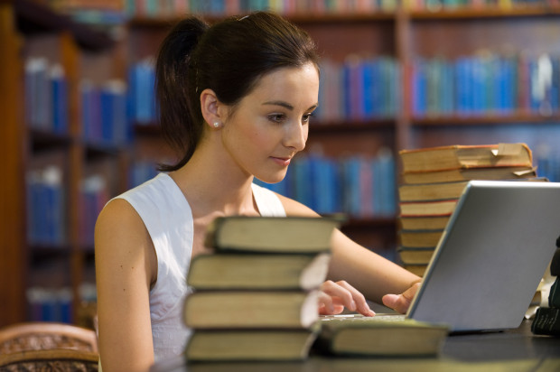 College Student Studying in Library