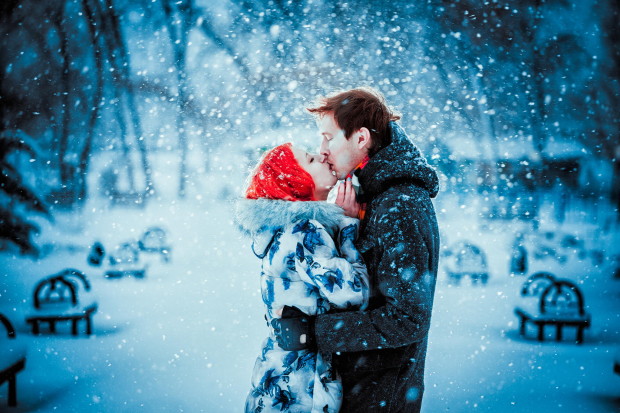 Happy Young Couple in Winter Park having fun.Family Outdoors. love kiss