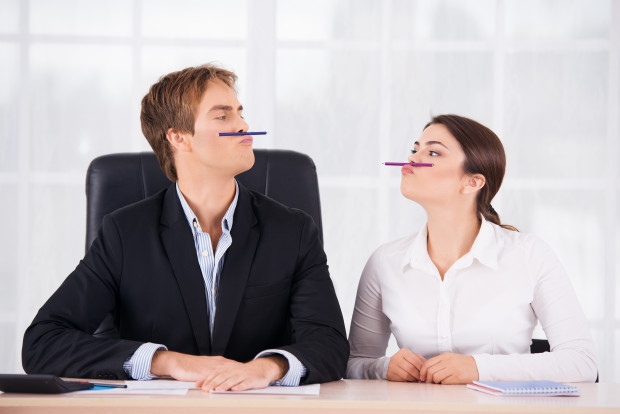 Business woman and man having fun in office