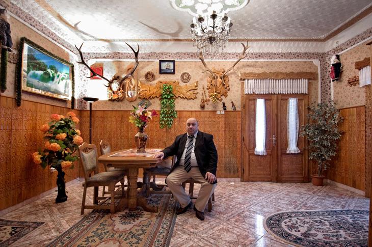 His every room, his trophy room, Gradjuli (Iasi), Romania. When furnishing their houses, Roma are attentive to a precise display of material wealth in museum-like dignity. Exotic, unusual and imperial objects are gathered from far-away places, and carefully arranged, to accentuate the abundant power of the family.