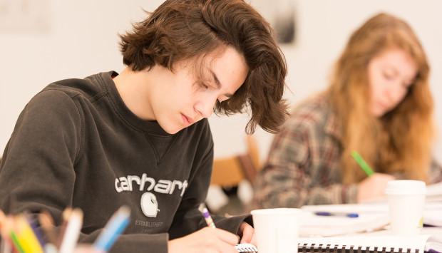 female-student-in-black-sweatshirt-writing