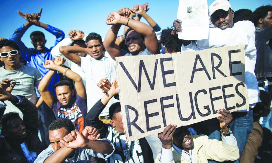 African migrants take part in a rally