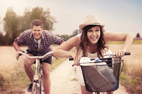 Happy couple racing on bikes