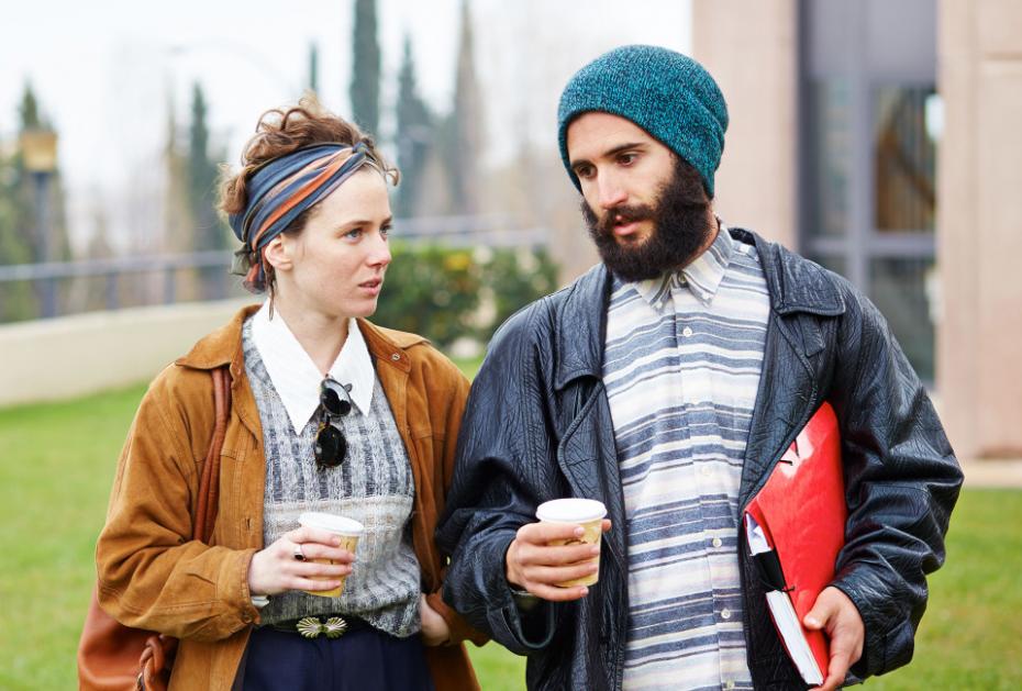 Hipster couple talking and drinking coffee to go at university campus