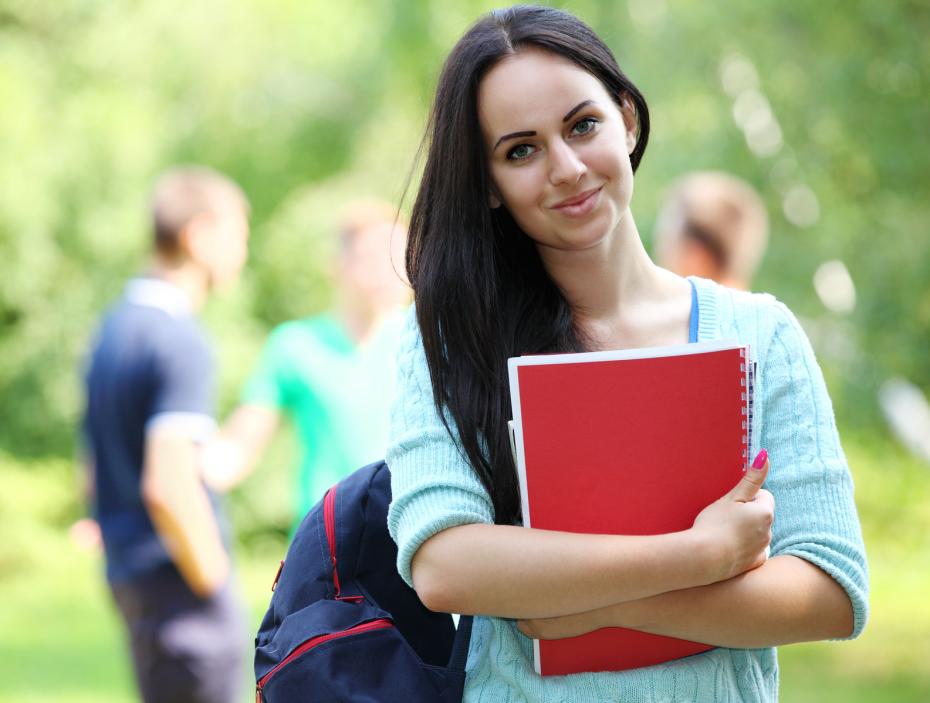 Outdoors portrait of a beautiful tanned teen student girl.