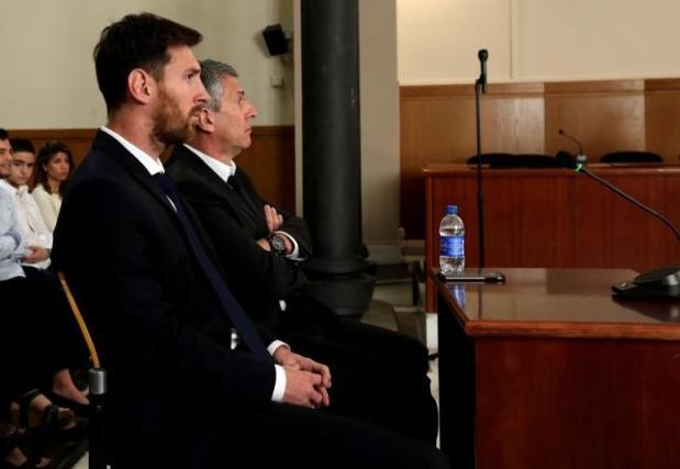 Barcelona’s Argentine soccer player Lionel Messi sits in court with his father Jorge Horacio Messi during their  trial for tax fraud in Barcelona