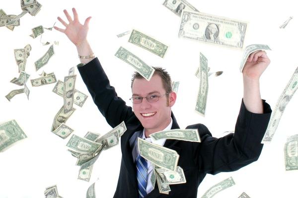 Attractive Business Man In Suit Throwing Money Into Air