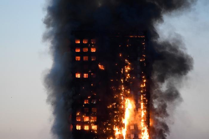 Flames and smoke billow as firefighters deal with a serious fire in a tower block at Latimer Road in West London