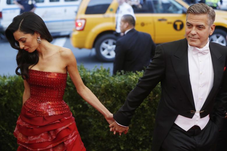 George Clooney and wife Amal Clooney arrive at the Metropolitan Museum of Art Costume Institute Gala 2015 celebrating the opening of "China: Through the Looking Glass," in Manhattan, New York May 4, 2015. REUTERS/Lucas Jackson