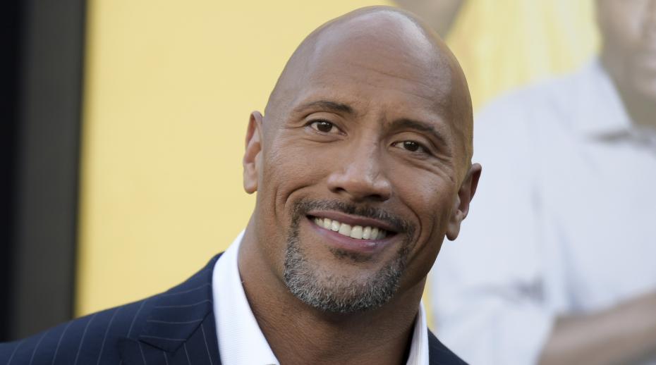 FILE - In this June 10, 2016 file photo, Dwayne Johnson attends the premiere of his film, "Central Intelligence" in Los Angeles. Johnson was named "Sexiest Man Alive" by People magazine on Nov. 15, 2016. (Photo by Richard Shotwell/Invision/AP, File)