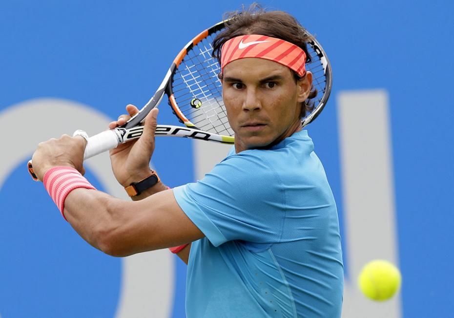 Spain’s Rafael Nadal plays a return shot to Ukraine’s Alexandr Dolgopolov during their men's singles tennis match at Queen's tennis championship in London, Tuesday June 16, 2015. (AP Photo/Tim Ireland)