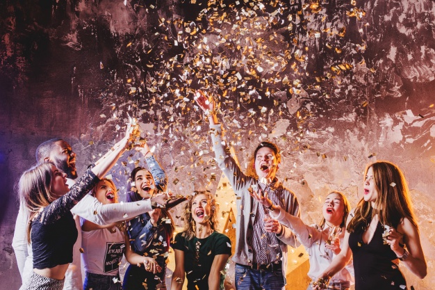 friends-having-fun-in-falling-confetti_23-2147651884