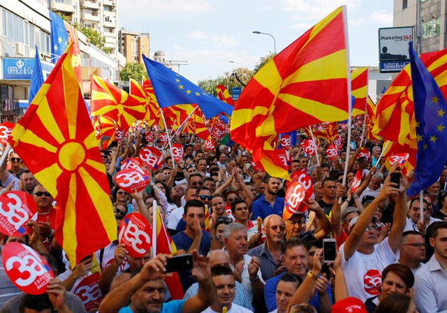 People hold placards reading ÔYes for European MacedoniaÕ during a march in support of a referendum in Skpoje