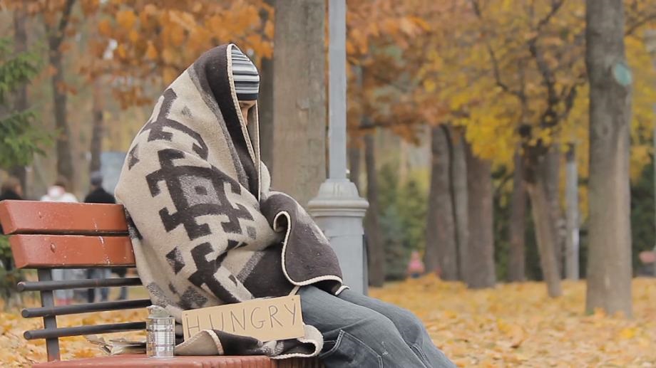 lonely-poor-person-sitting-on-bench-warming-up-with-old-blanket-man-starving_rawmum_7__F0000-920×517