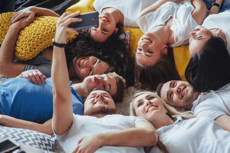 Group beautiful young people doing selfie lying on the floor, best friends girls and boys together having fun, posing emotional lifestyle  concept
