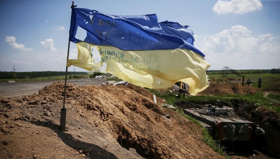 A tattered Ukrainian national flag flutters in the wind at a position held by the Ukrainian armed forces near the town of Maryinka