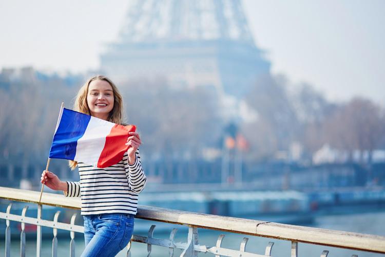 Beautiful young girl with French national flag