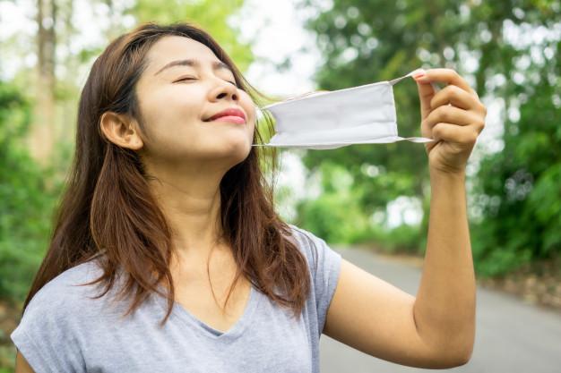 asian-take-off-face-mask-breath-deep-fresh-air-nature_34670-976