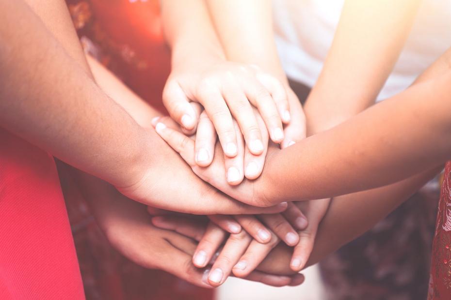 Children holding hands and playing together with unity and teamwork