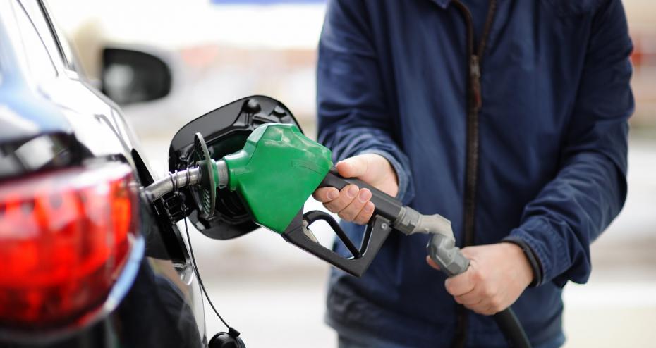 loseup Of Man Pumping Gasoline Fuel In Car At Gas Station