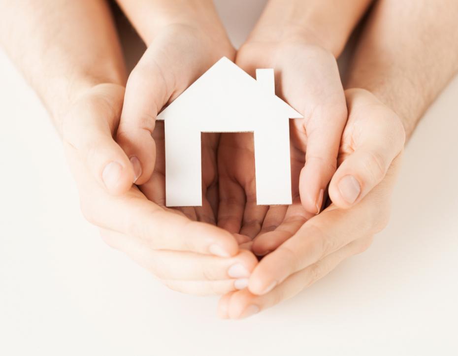 woman and hands with paper house