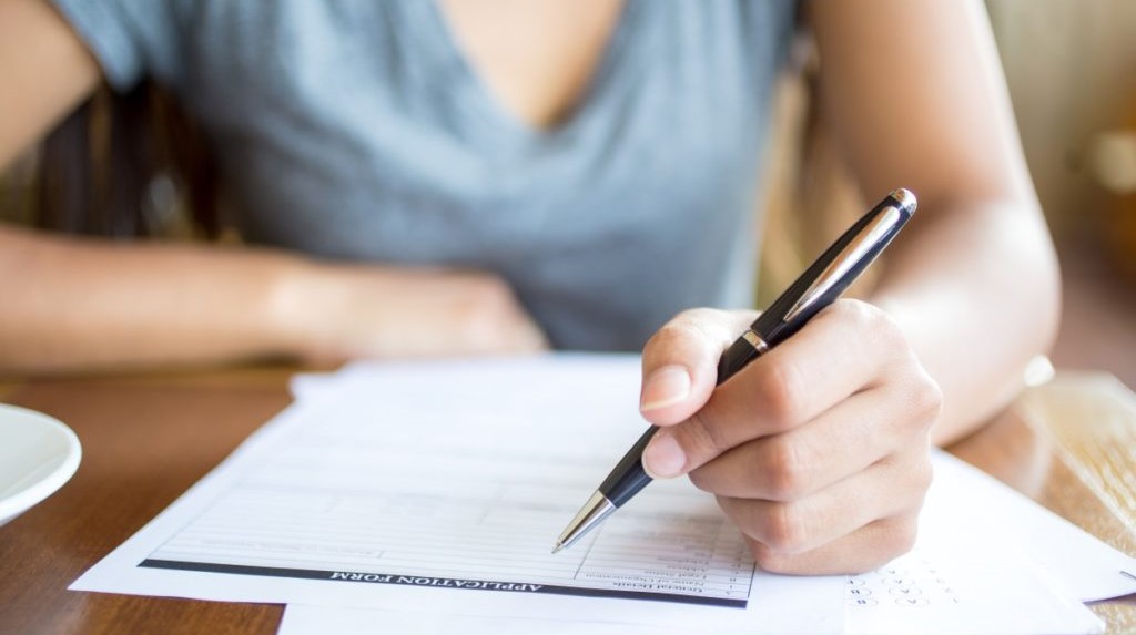 Close-up of woman filling application form